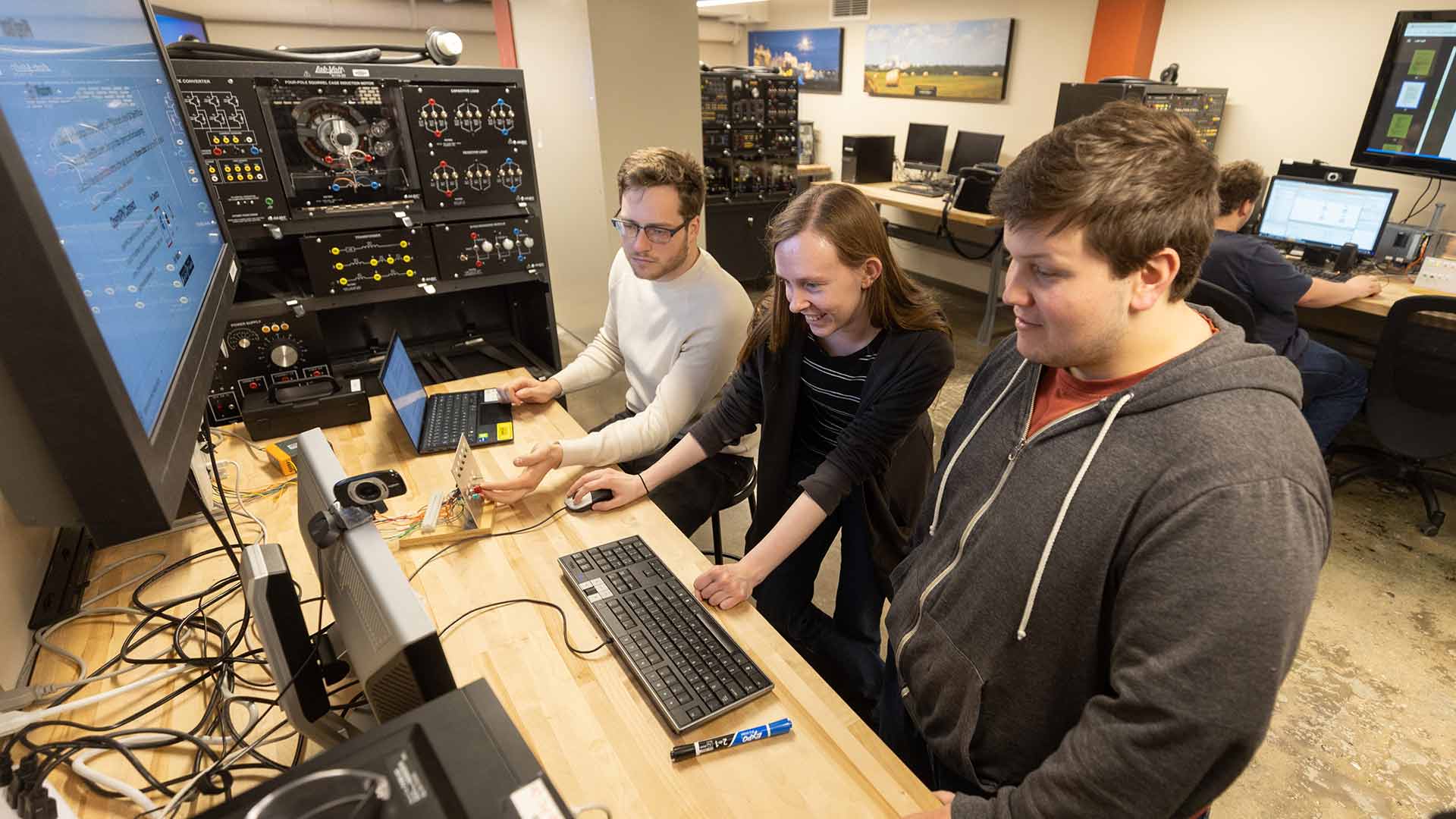 Three students in an engineering lab.