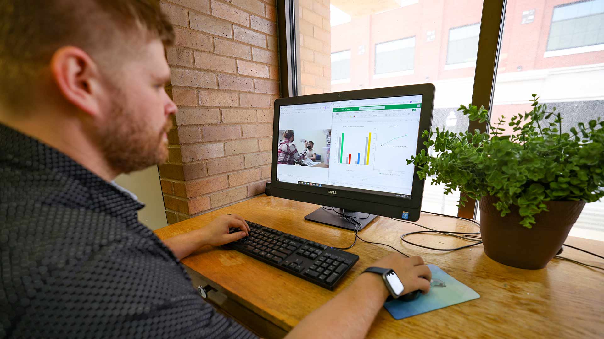 A person doing data analysis on a spreadsheet on his laptop.