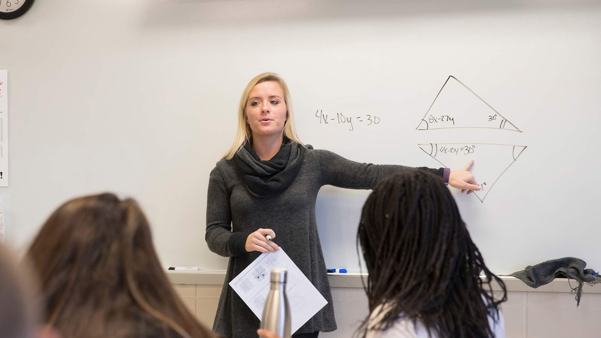 A student-teacher teaching a high school math class.