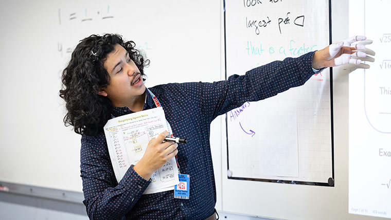 A student-teacher teaching a high school math class.
